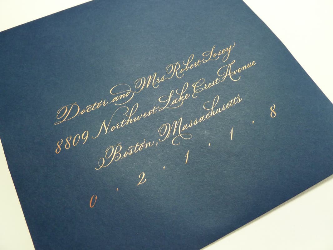 A close up of a wedding invitation with elegant calligraphy